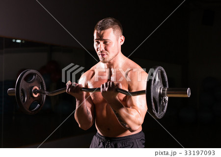 Muscular man working out in gym doing exercises Muscular man working out in gym doing exercises 33197093