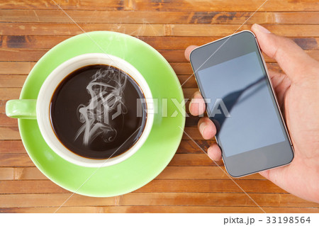 cup and smartphone cup and smartphone 33198564