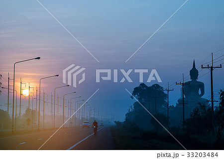 Silhouette the sunrise, the road, the big buddha w 33203484