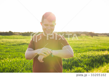 Close-up of Male runner jogging outside looking at 33205102
