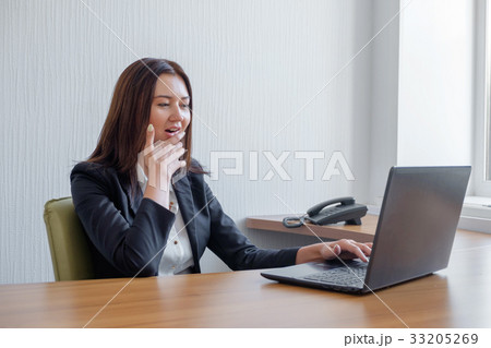 Young business woman is amused by what she saw on 33205269