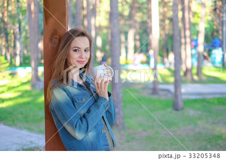 Beautiful young woman , drinking takeaway coffee Beautiful young woman , drinking takeaway coffee 33205348