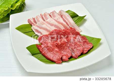 焼肉用の生肉／上段=豚肉、豚バラ肉、下段=牛肉、国産交雑牛の牛モモ肉。皿奥の緑の葉はサンチュです。 33205678