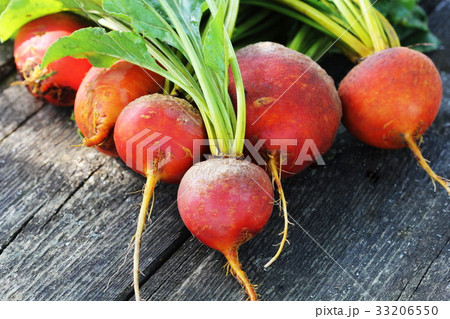 Raw organic golden beets on wooden background Raw organic golden beets on wooden background 33206550