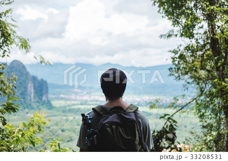 Young photographer with backpack enjoying nature 33208531