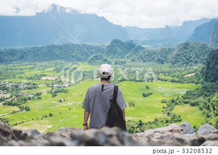 Young man with backpack enjoying beautiful nature 33208532