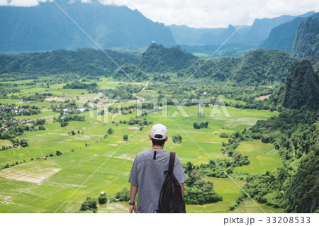 Young man with backpack enjoying beautiful nature 33208533