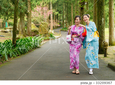 happy traveler women walking on tree path in japan happy traveler women walking on tree path in japan 33209367