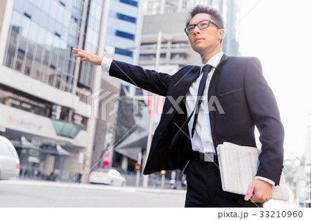 Waving for a taxi in city Waving for a taxi in city 33210960