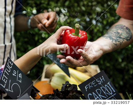 People Buying Vegetable From Shop at Market 33219057