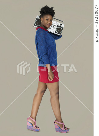 African Descent Woman Holding Jukebox 33220677