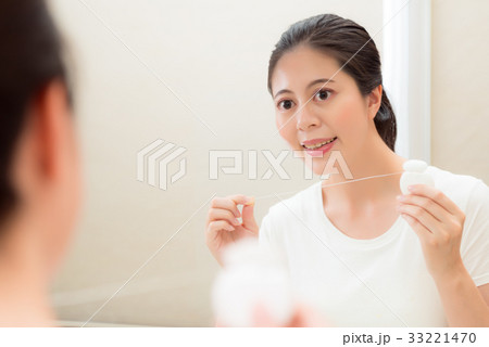young beautiful female student holding floss young beautiful female student holding floss 33221470