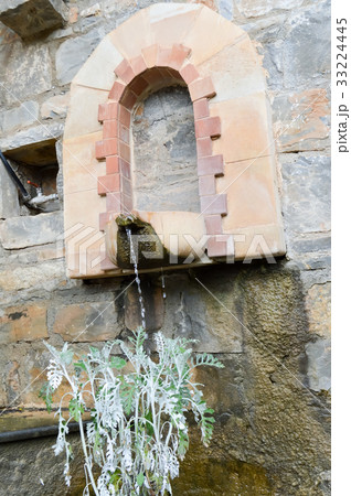 Blue stone fountain with a fresco of rural 33224445