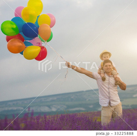 Father and son playing with balloons on lavender Father and son playing with balloons on lavender 33225888