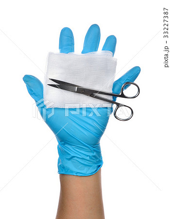 Hands of a medic wearing a blue latex gloves Hands of a medic wearing a blue latex gloves 33227387