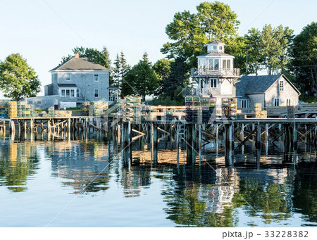 Houses docks stacked with lobster traps reflecting 33228382