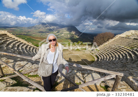 Tourist taking photo in front of greek theater of 33230481
