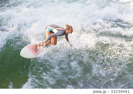 Atractive sporty girl surfing on famous artificial 33230491