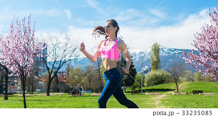 Woman running fast for sport on sunny day Woman running fast for sport on sunny day 33235085