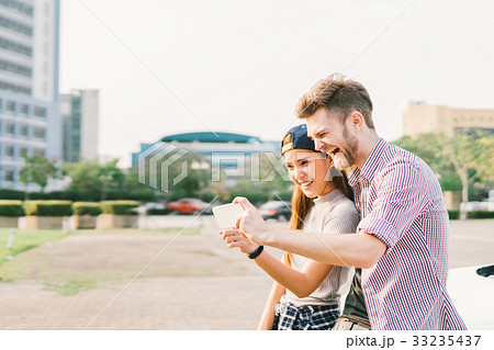 Multiethnic young couple enjoy taking selfie 33235437