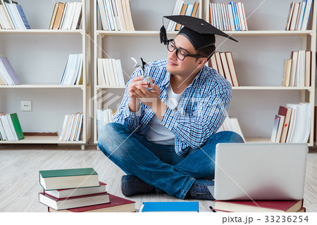 Young student studying with books Young student studying with books 33236254