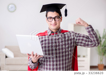 Super hero student wearing mortarboard and holding Super hero student wearing mortarboard and holding 33236620