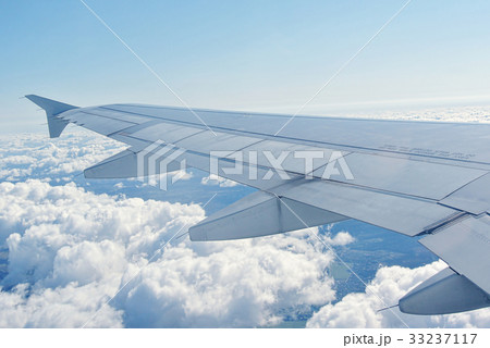Clouds under the wing of an airplane 33237117