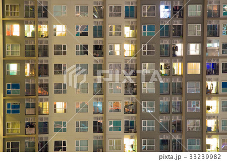 Glowing apartment windows at nigh high rise 33239982