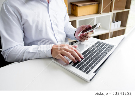 Man holding credit card in hand and entering security code using Man holding credit card in hand and entering security code using 33241252