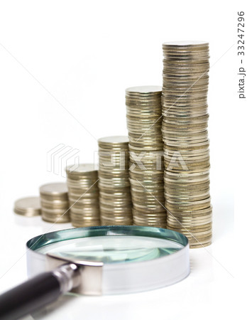 coin stack and magnifying glass coin stack and magnifying glass 33247296