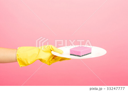 Hands in yellow protective gloves washing a plate Hands in yellow protective gloves washing a plate 33247777