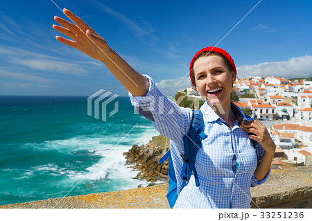 Woman with a backpack makes a welcome hand gesture Woman with a backpack makes a welcome hand gesture 33251236
