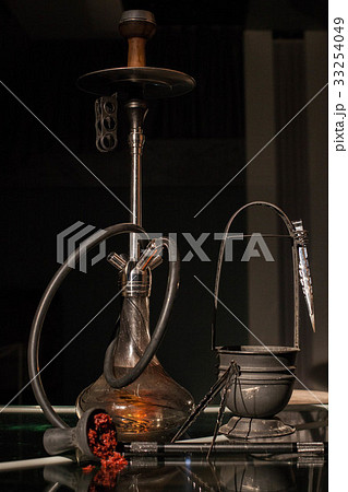 Orange shisha with all accessories placed on the Orange shisha with all accessories placed on the 33254049