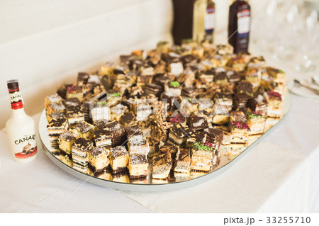 Delicious and tasty dessert table with cupcakes 33255710