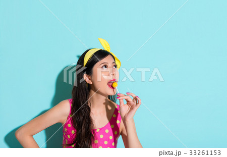 closeup of young beautiful woman in blue wall closeup of young beautiful woman in blue wall 33261153