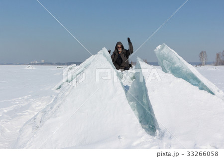 Man in sunglasses climbing a cracked ice Man in sunglasses climbing a cracked ice 33266058