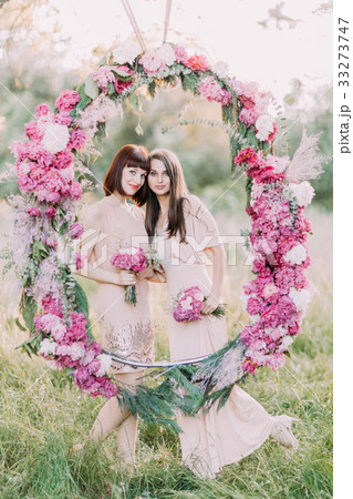 The lovely portrait of the two bridesmaids holding The lovely portrait of the two bridesmaids holding 33273747