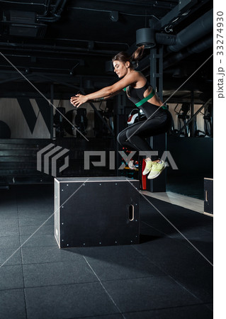 Young woman doing a box jump exercise. 33274930
