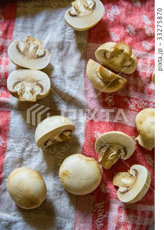 Fresh raw mushrooms on cloth with nkife 33275870
