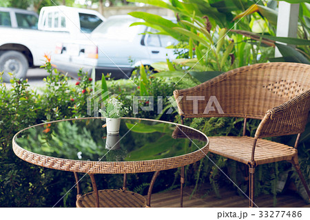glass table and rattan wicker seat decoration 33277486