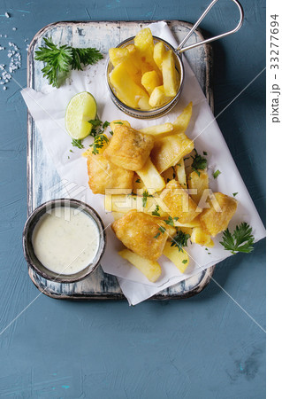 Fish and chips with sauce 33277694