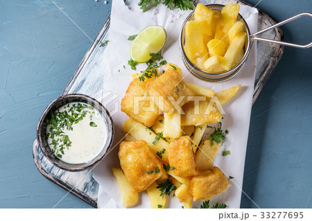 Fish and chips with sauce 33277695