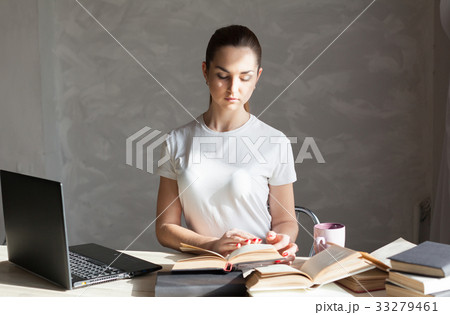 girl is preparing for the exam reading book works 33279461