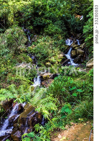 Beautiful waterfall in the jungle at sunny day Beautiful waterfall in the jungle at sunny day 33280883