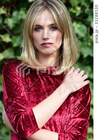 Beautiful young blonde woman in green leaves background Beautiful young blonde woman in green leaves background 33288530