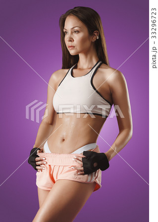 Muscular young woman athlete posing at studio Muscular young woman athlete posing at studio 33296723