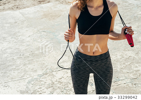 Cropped image of a girl in a bra and sweat pants 33299042