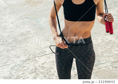 Sporty girl looks at the tense muscles 33299043