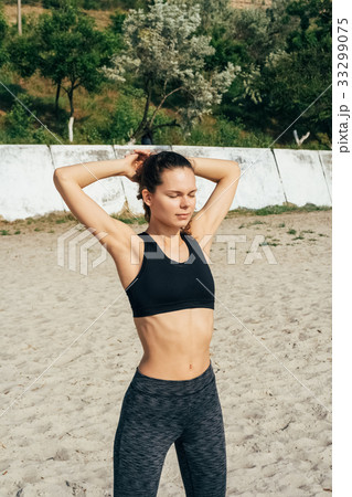 Young slim girl in sportswear doing exercises Young slim girl in sportswear doing exercises 33299075