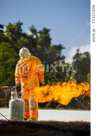 Fireman with fire and suit for protect. 33303806
